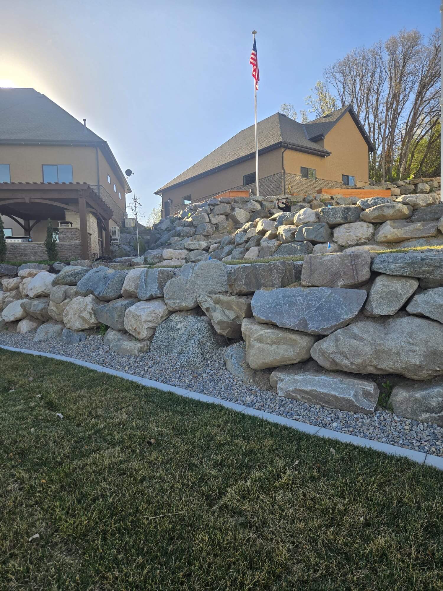 Large natural boulder retaining wall in a Northern Utah neighborhood